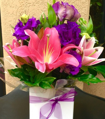 We love you - "WE LOVE YOU" is a mix of  hot pink Lillies and purple lissies in a box